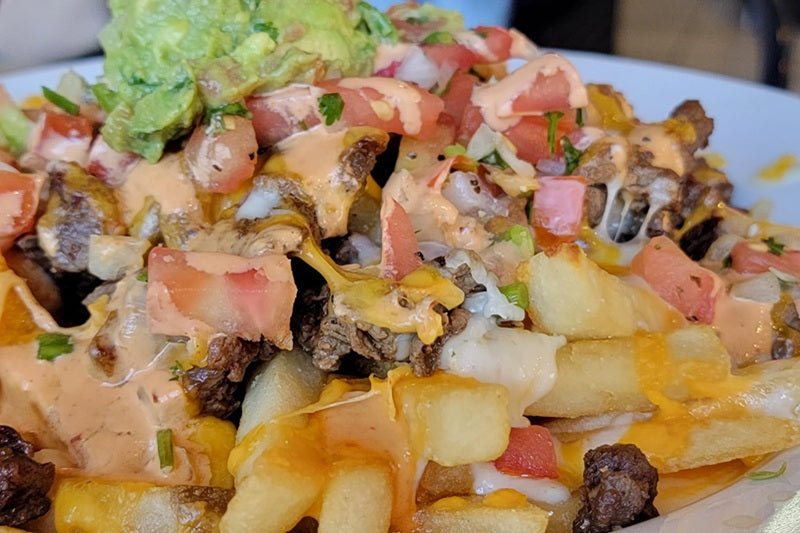 Best Fast Casual Mexican San Clemente Carne Asada Fries Topepd with Cheese, Pico de Gallo, Carne Asada, and Guacamole