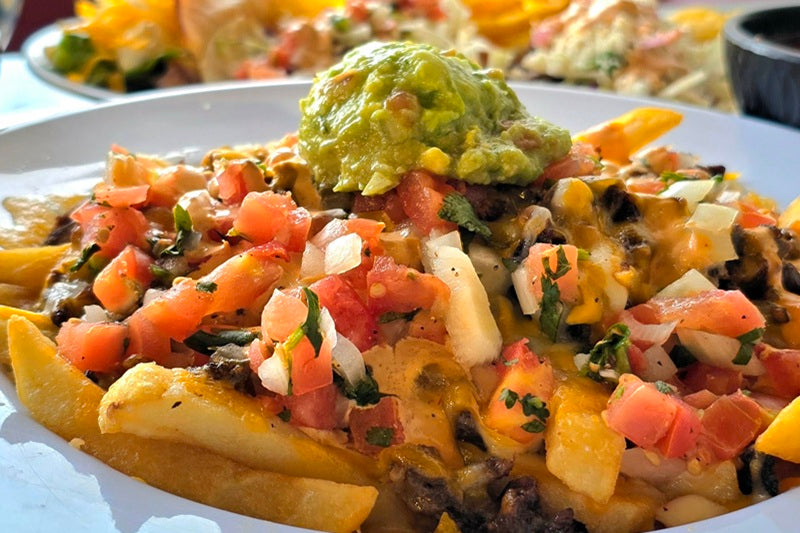 Best Place to Grab a Bite to Eat in Laguna Beach a Plate of Carne Asada Fries Topped with Pico de Gallo, Cheese, and Guacamole
