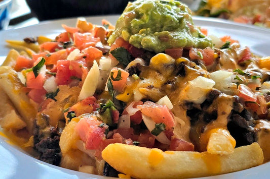 Best Place to Grab a Bite to Eat in South OC a Plate of Carne Asada Fries, a Plate of Tacos, and a Plate of Carne Asada Fries Topped with Cheese, Beans, Pico de Gallo, and Guacamole